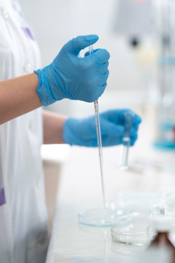 Crafting Captivating Headlines: Your awesome post title goes here Close-up of a lab technician using a dropper in scientific research.